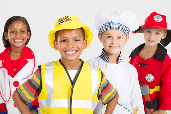Photo of children dressed as a doctor, fireman, chef, and safety officer representing the 2017 Children's Summit