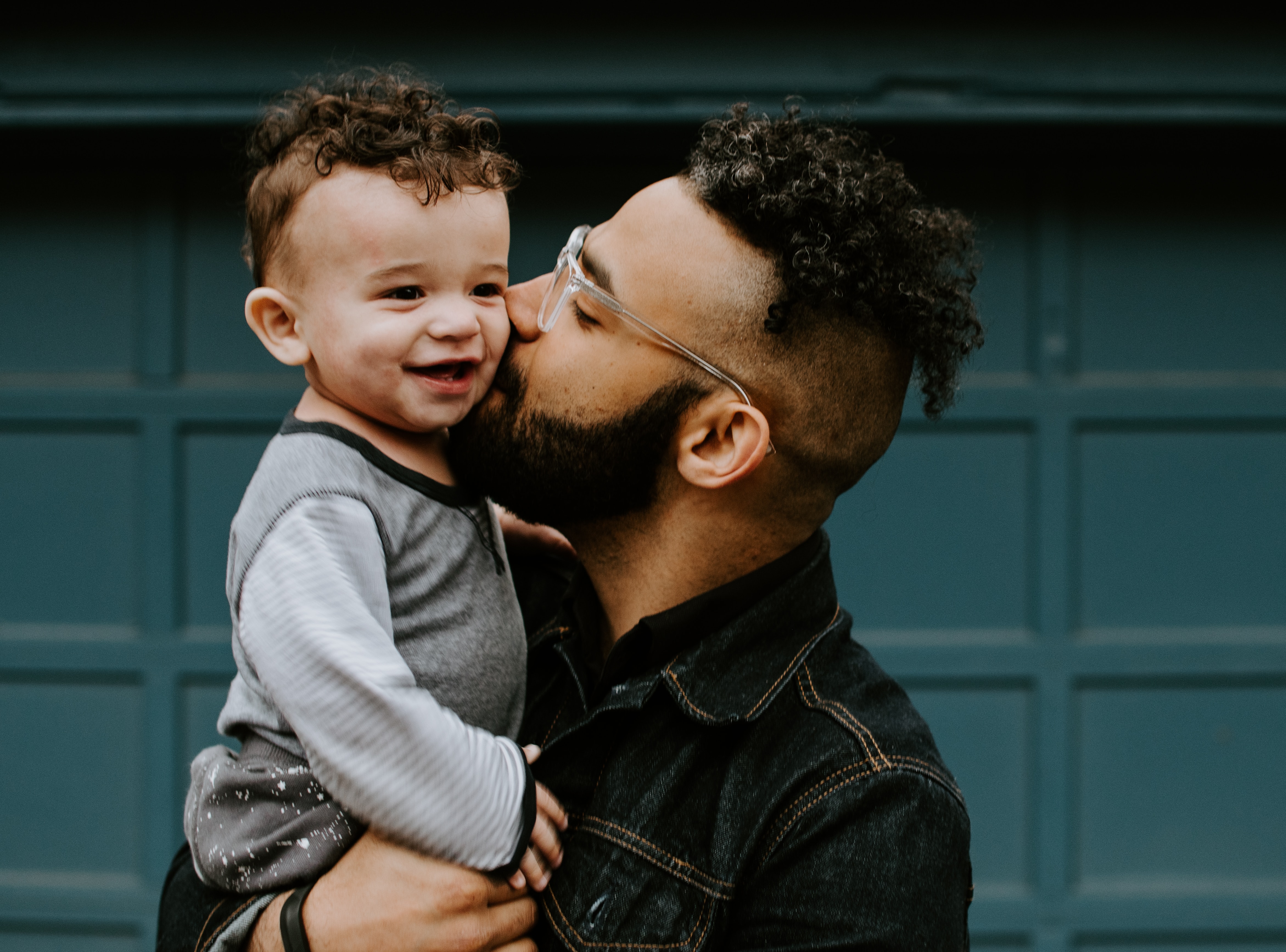 Father kissing his toddler son