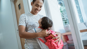 Dad hugging daughter who is going back to school