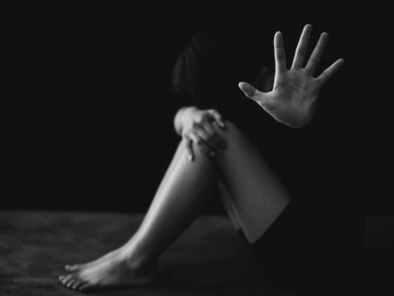 Black and white photo of depressed girl sitting on floor