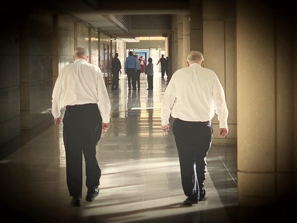 Former JWB Board Members: Pinellas-Pasco Public Defender Bob Dillinger and former Pinellas-Pasco State Attorney Bernie McCabe walking in hallway