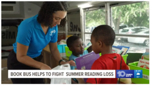 JWB Staff helps kids choose books on the JWB Book Bus