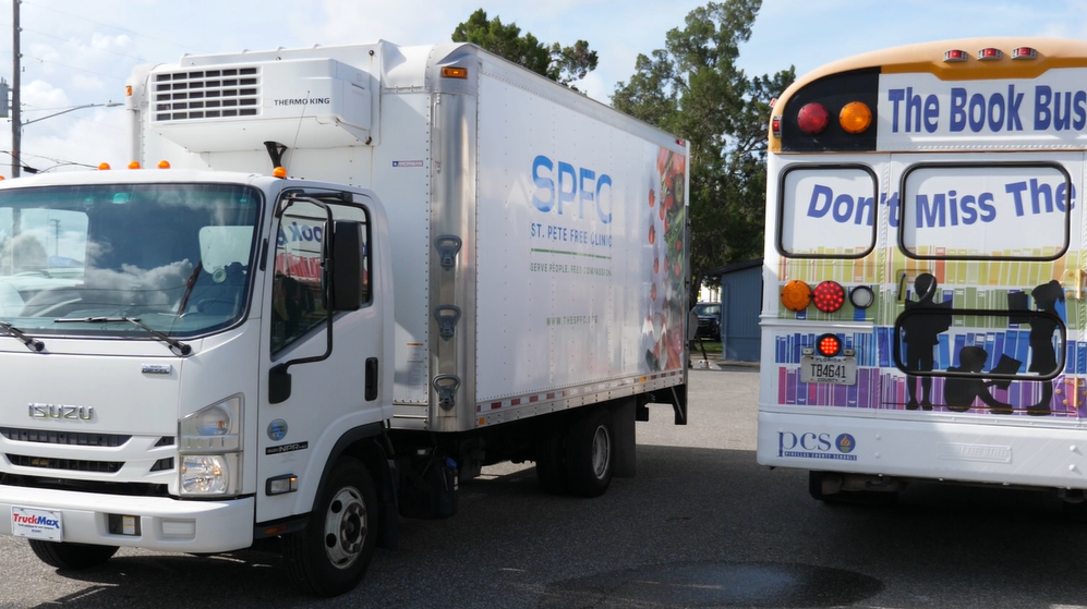 St. Pete Free Clinic truck with book bus