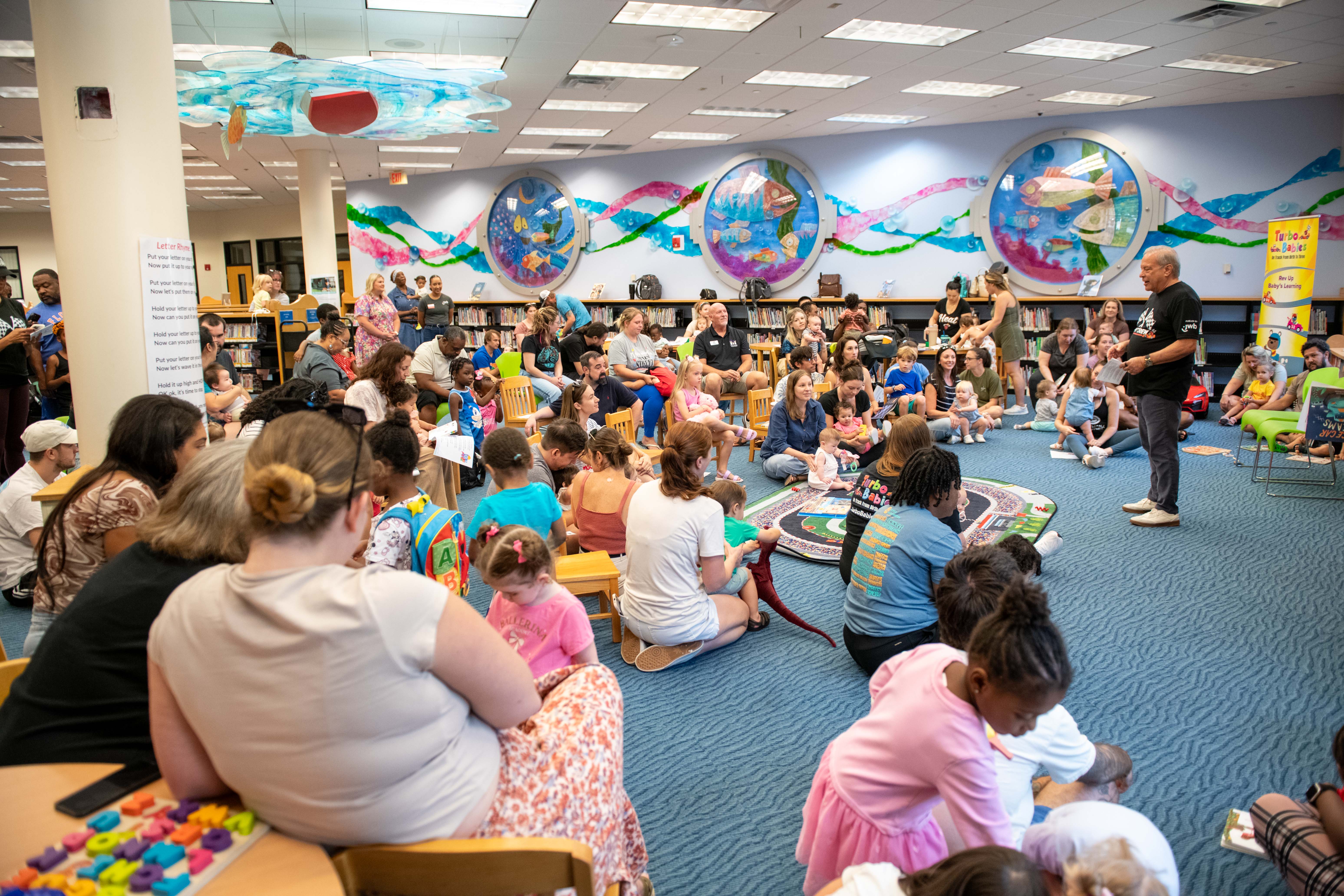 JWB Interim CEO speaks to parents and babies at the TUrbo Baies read along event on Sep 6