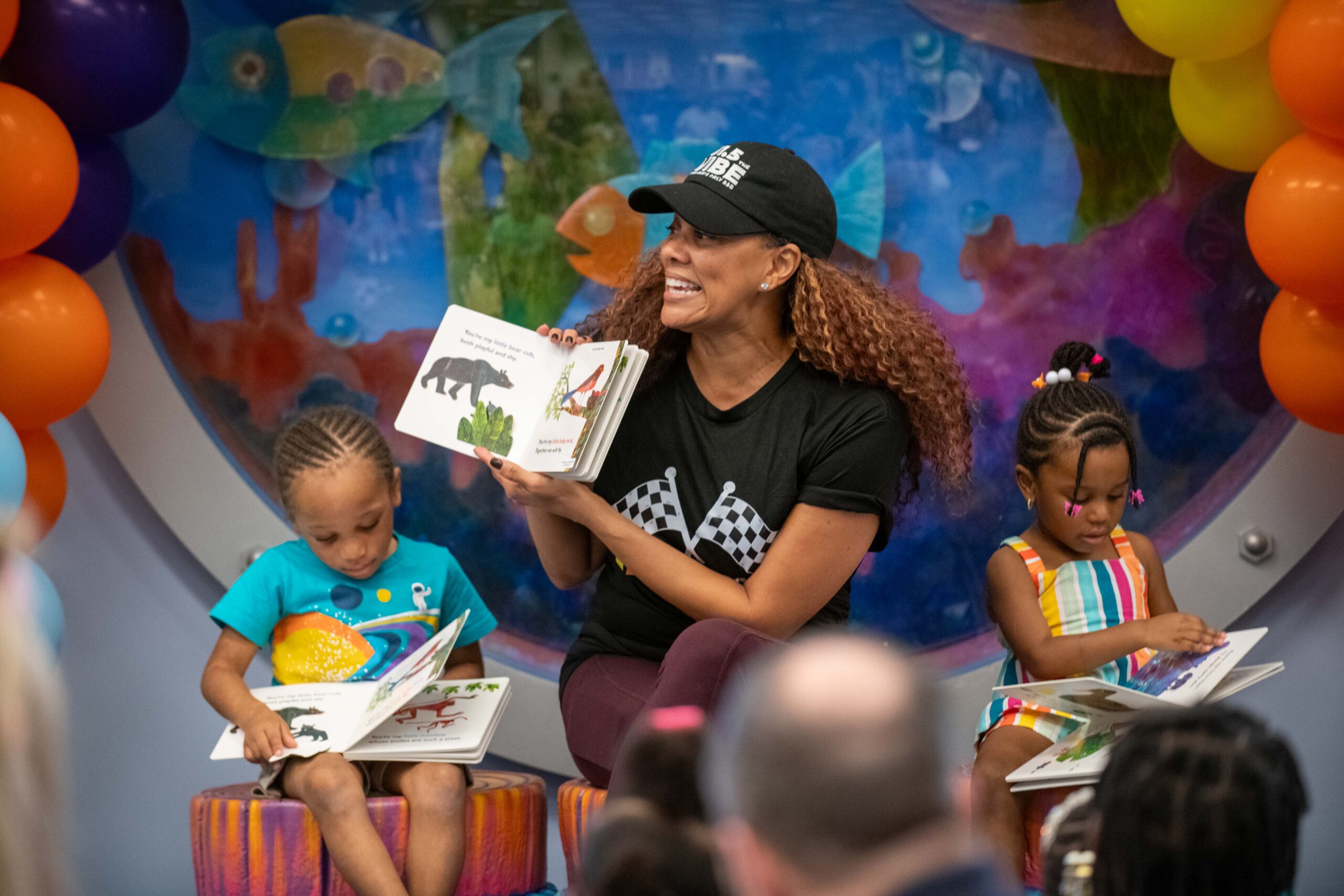 Hazely Lopez of Univision, a guest reader at the Turbo Babies read along event, show the page of the book to the audience
