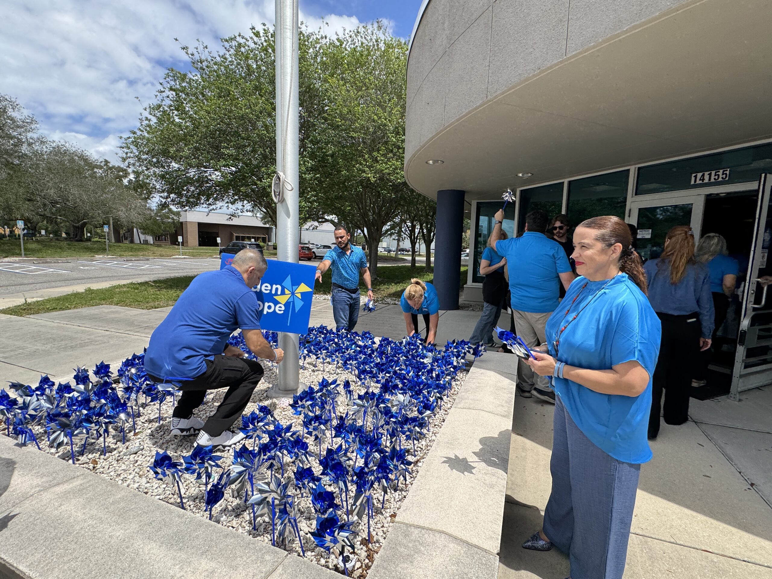 JWB staff planted a pinwheel garden ahead of Wear Blue Day in CAP Month